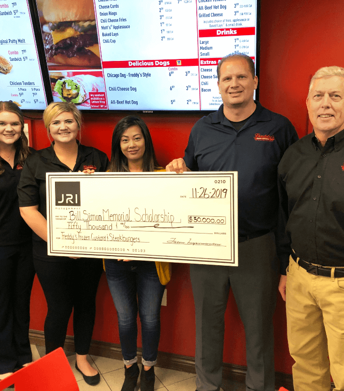 Five people holding a check from JRI