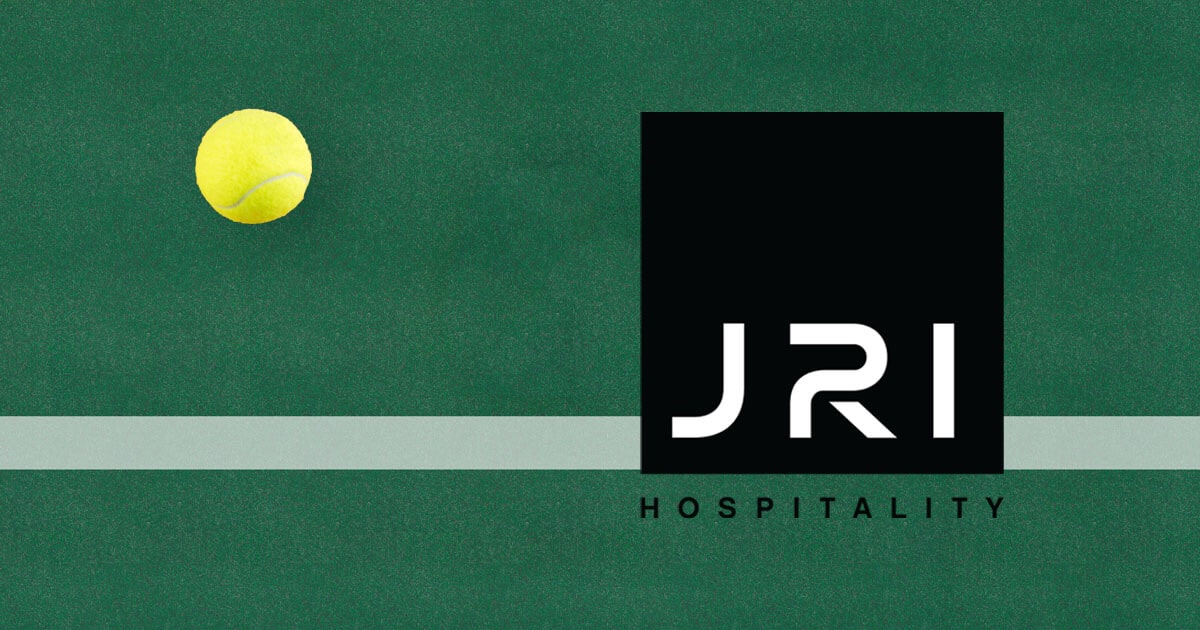 JRI Hospitality Logo on a Pines Tennis Court